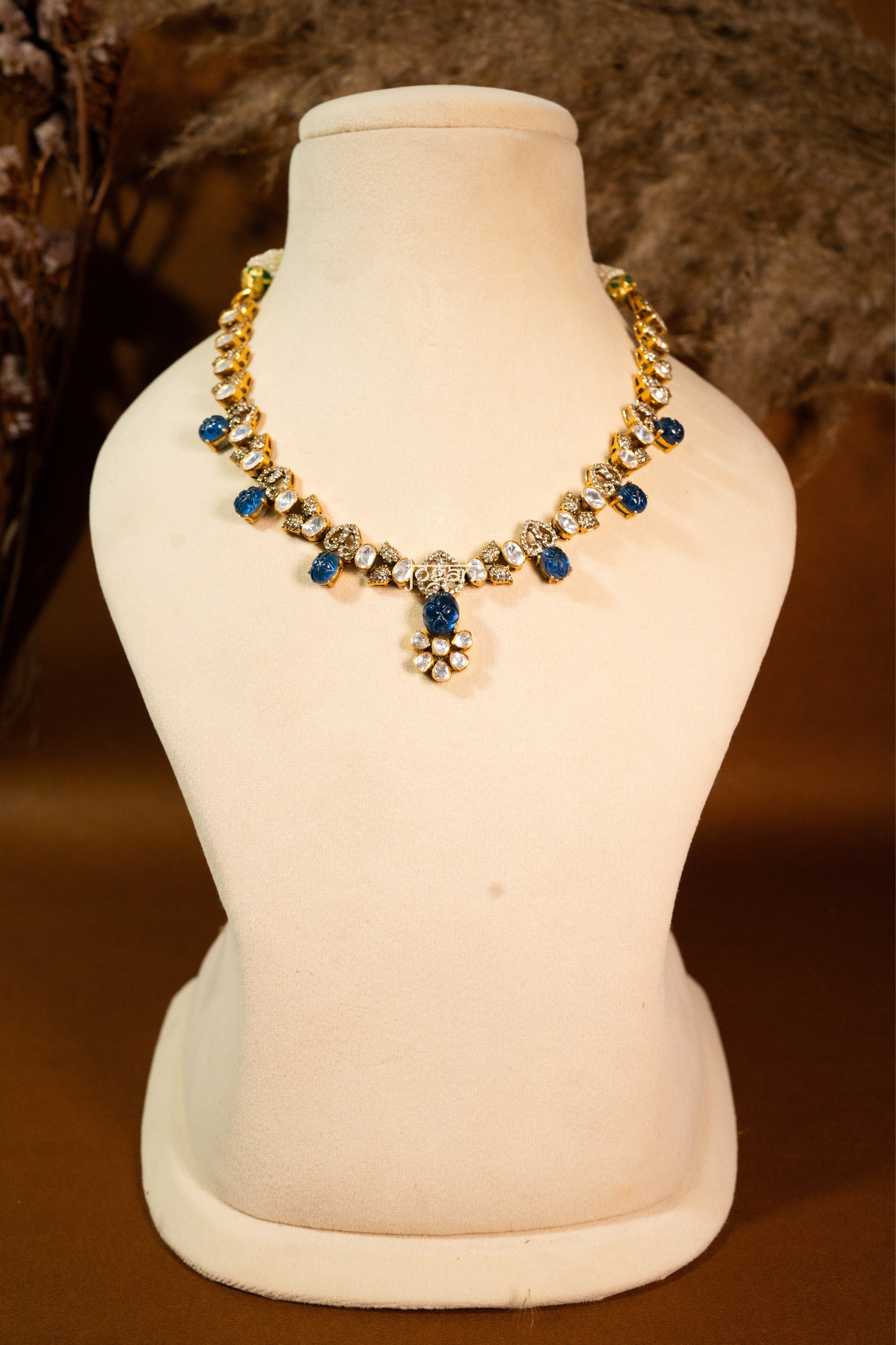Indraneel necklace set with lab grown polkis, gold-plated 92.5 sterling silver and deep blue carved semi-precious stones, inspired by royal Indian heritage.
