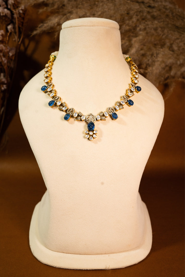 Indraneel necklace set with lab grown polkis, gold-plated 92.5 sterling silver and deep blue carved semi-precious stones, inspired by royal Indian heritage.
