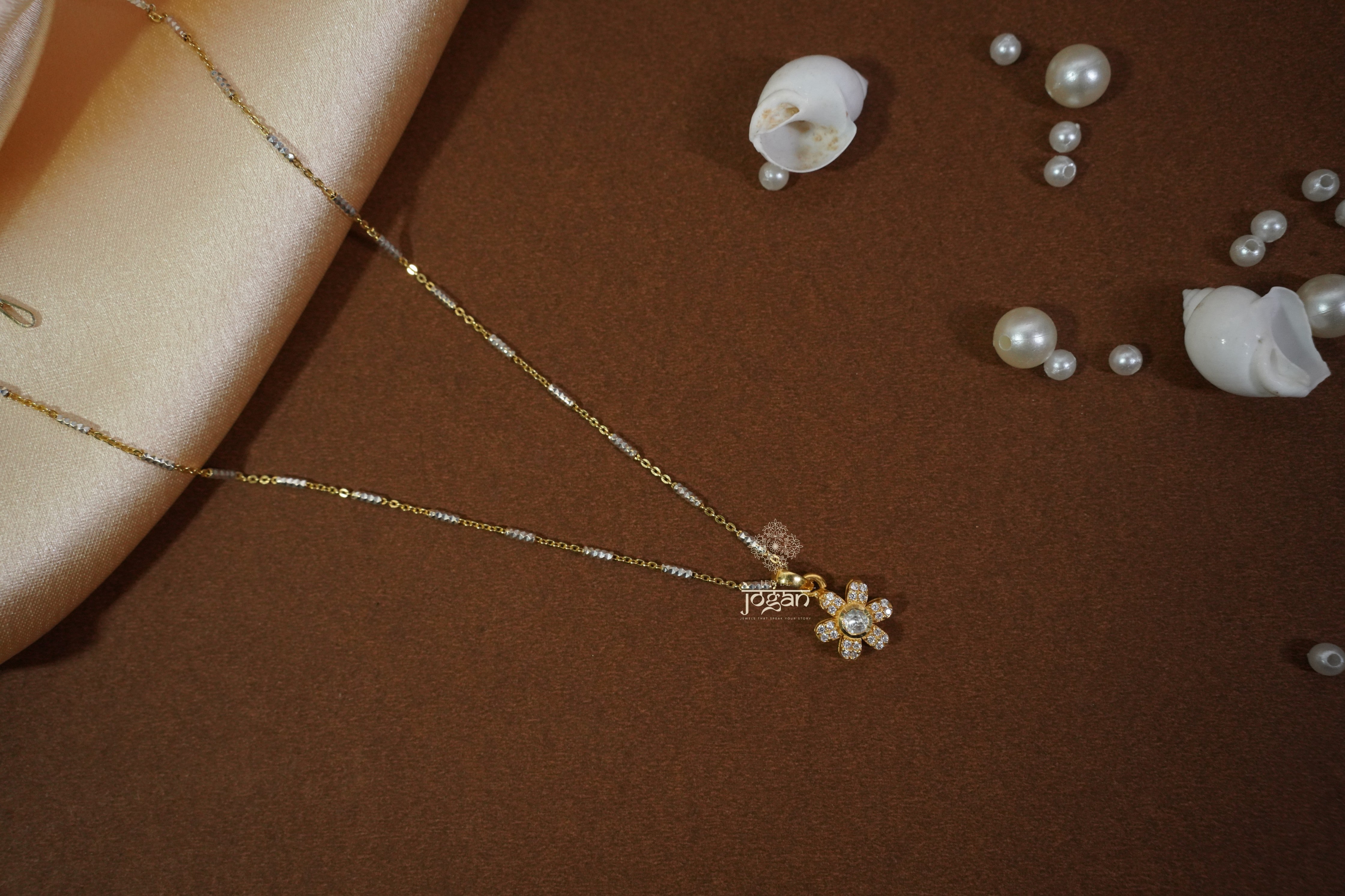 Gold-plated silver pendant, floral motif with lab grown polki and CZ stones, openwork details.

