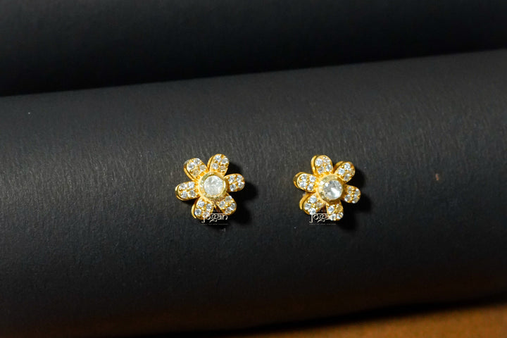 Floral drop earrings in gold-polished silver, lab grown polki and Cz stones, delicate flower detail.
