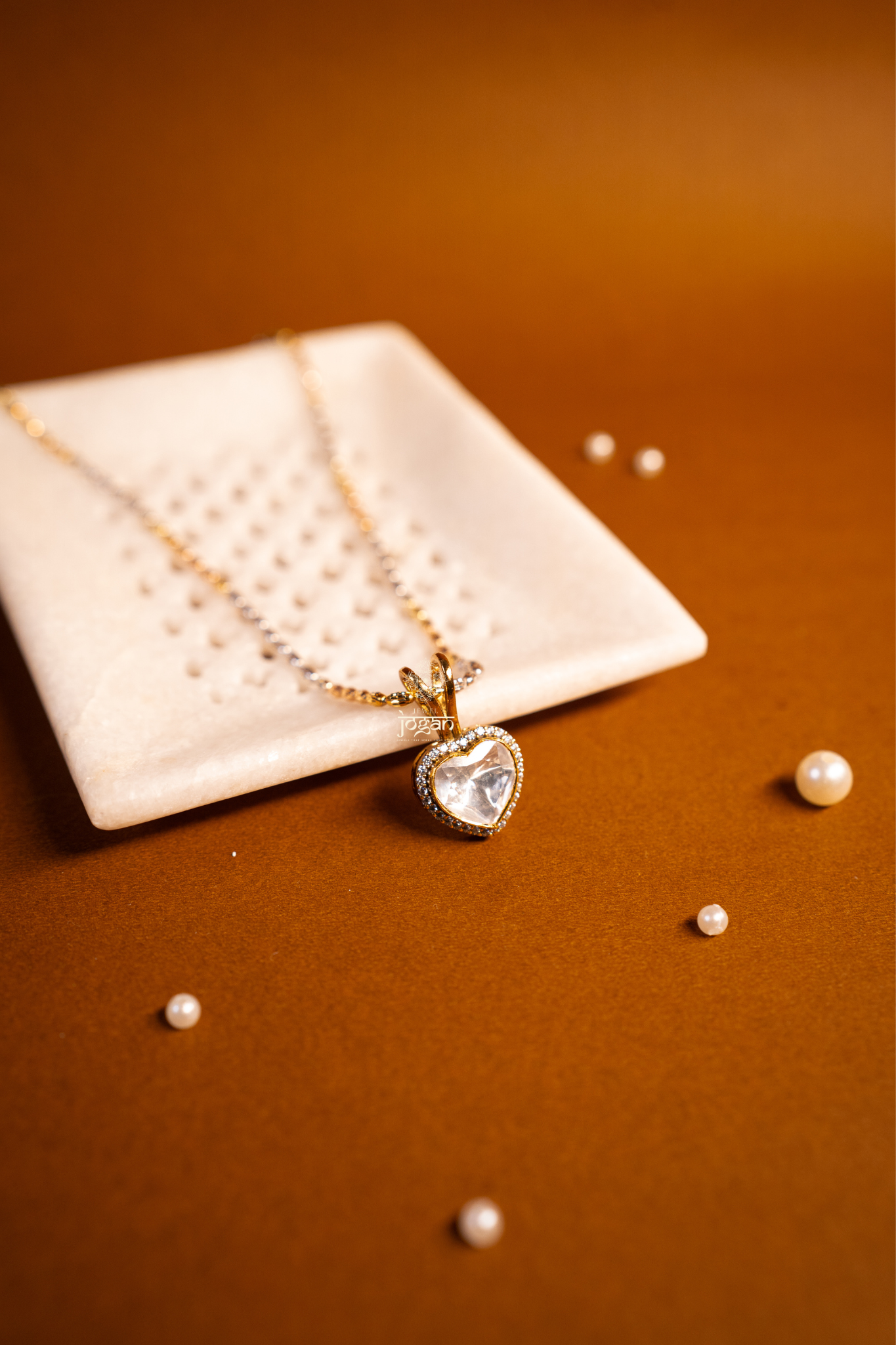 Heart-shaped gold-plated silver pendant with lab grown polki stones and CZs, floral etching.
