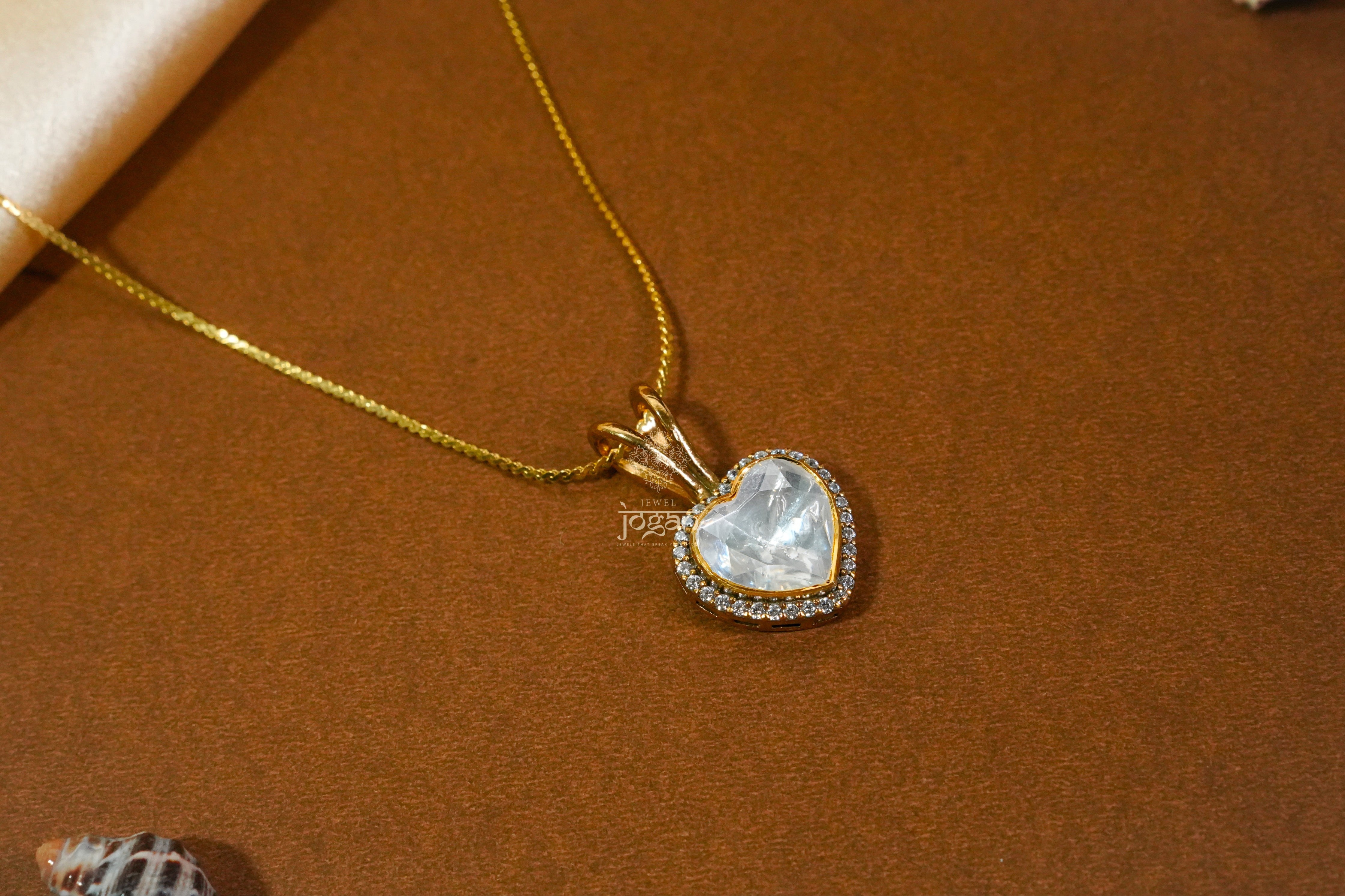 Heart-shaped gold-plated silver pendant with lab grown polki stones and CZs, floral etching.
