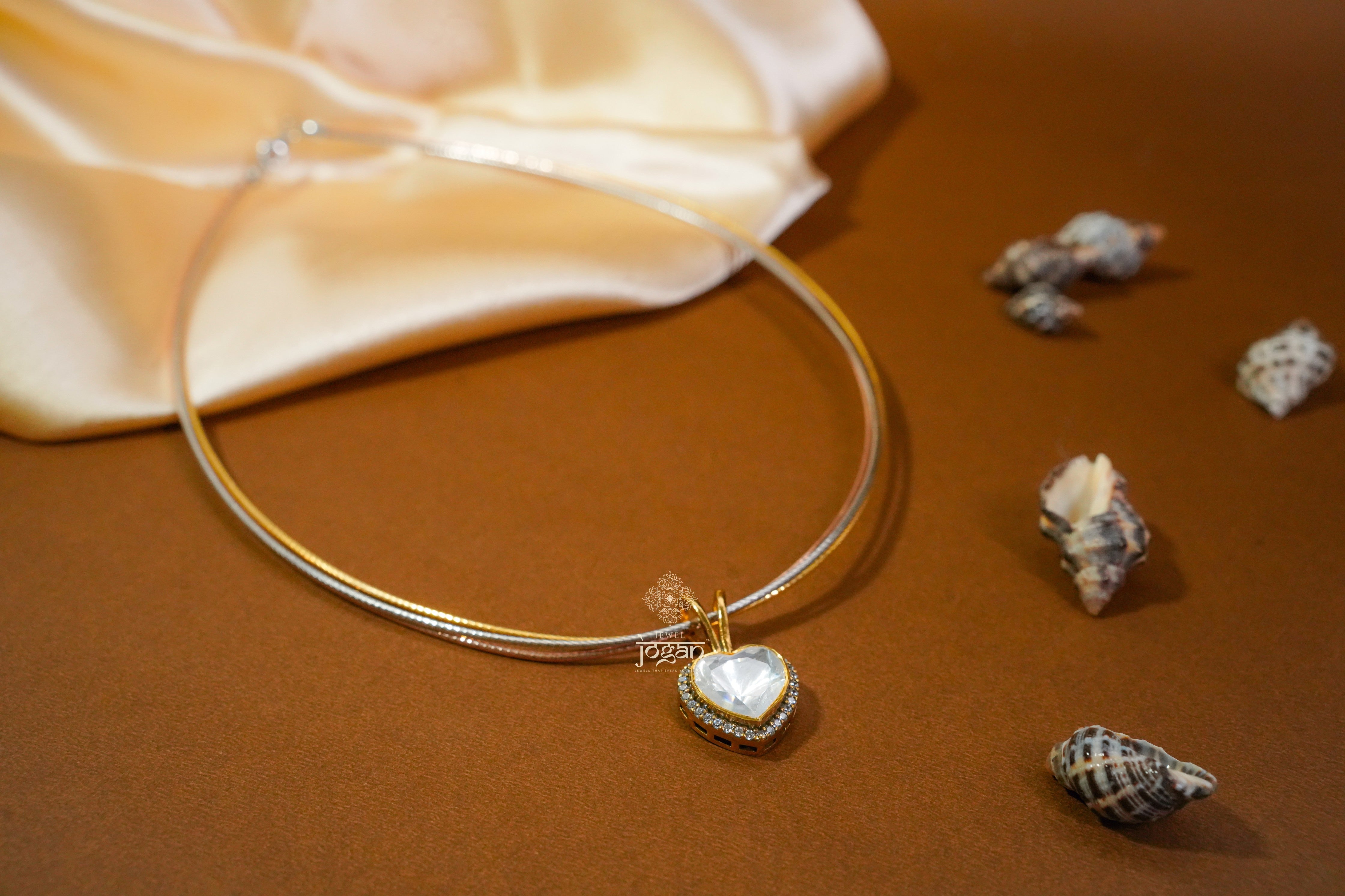 Heart-shaped gold-plated silver pendant with lab grown polki stones and CZs, floral etching.