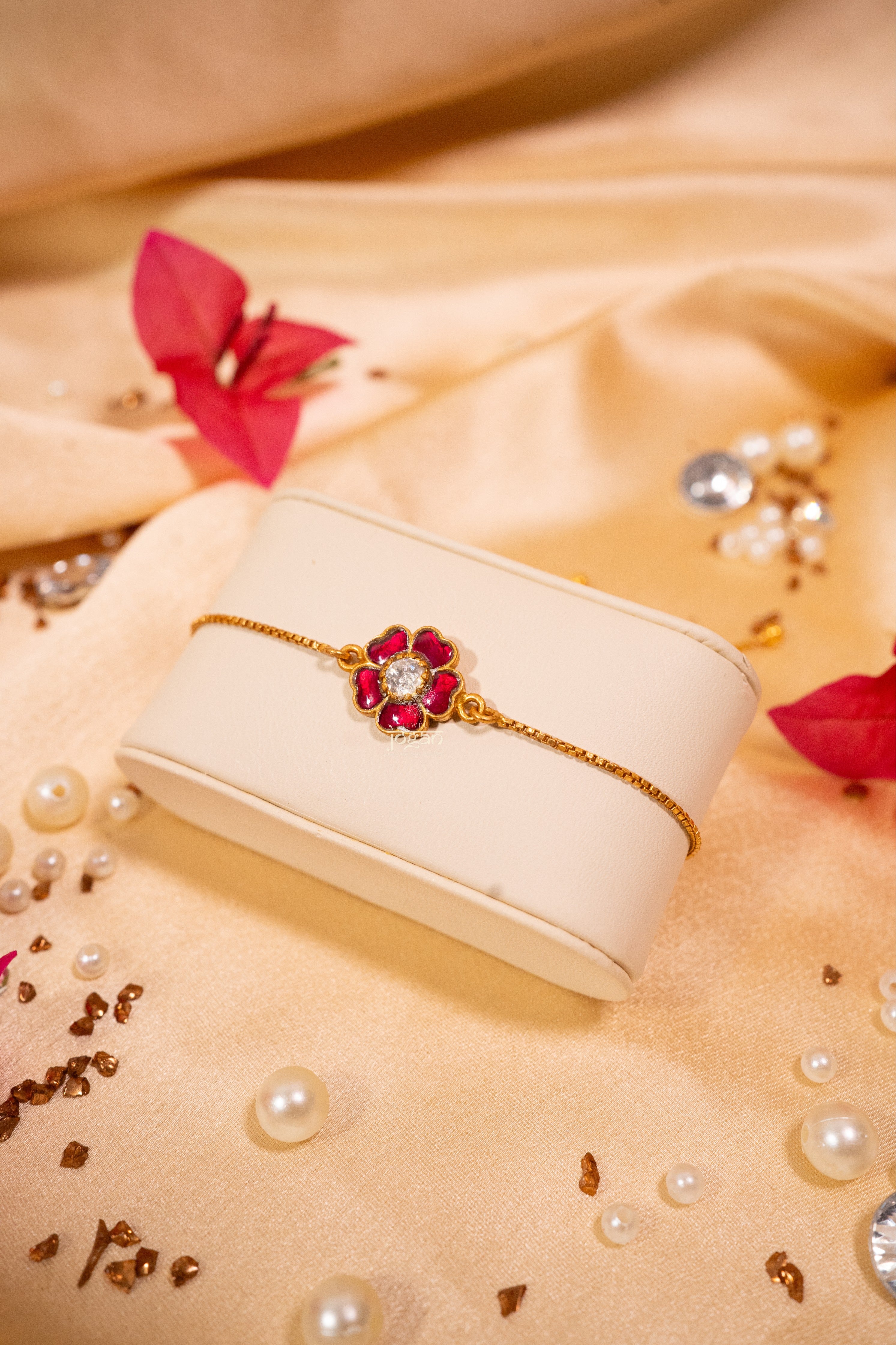 Adjustable festive bracelet in 92.5 sterling silver with gold plating, featuring lab grown polki pink/red semi precious stones (kundan setting) and floral-inspired design
