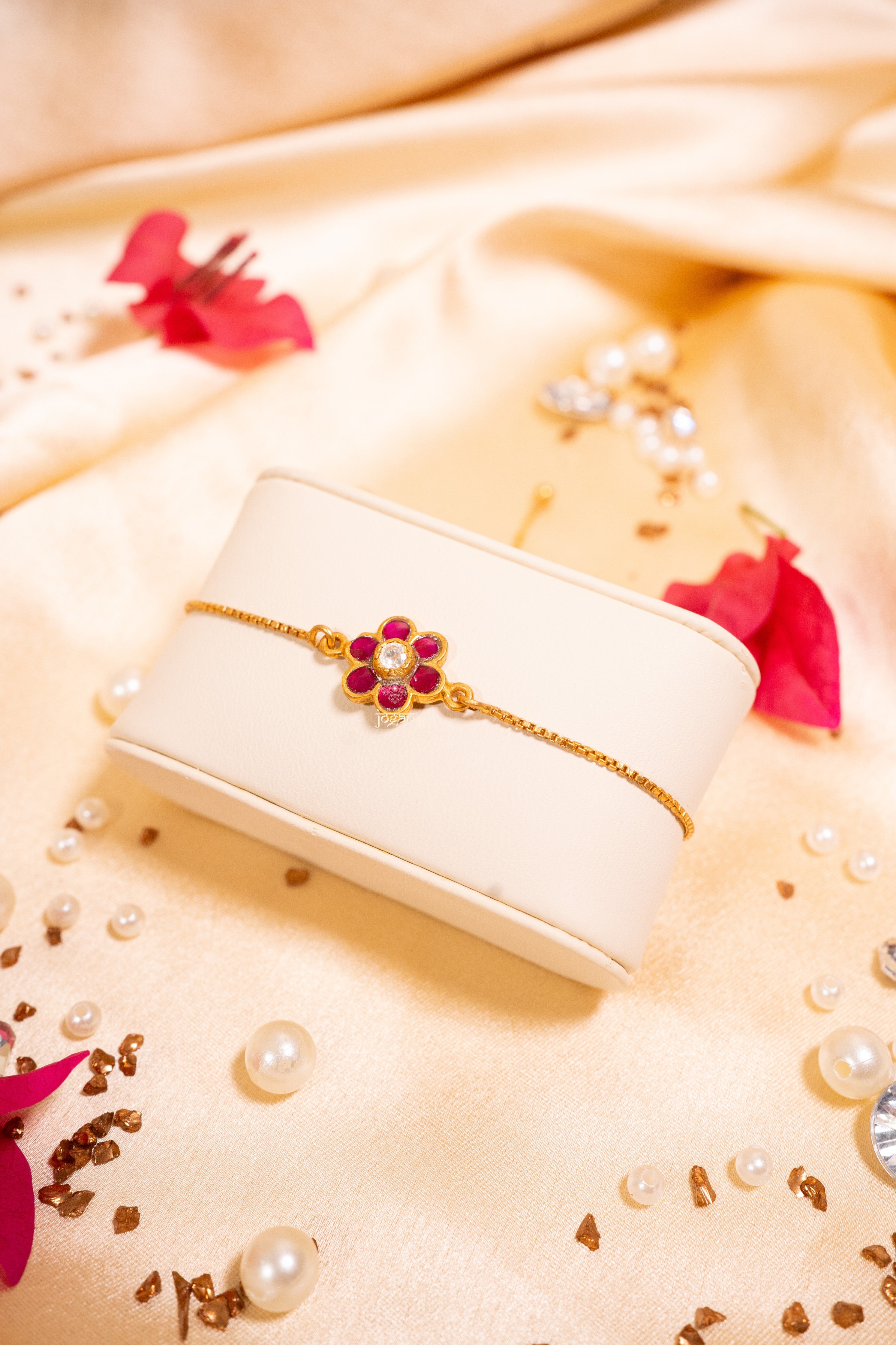 Adjustable festive bracelet in 92.5 sterling silver with gold plating, featuring lab grown polki pink/red semi precious stones (kundan setting) and floral-inspired design
