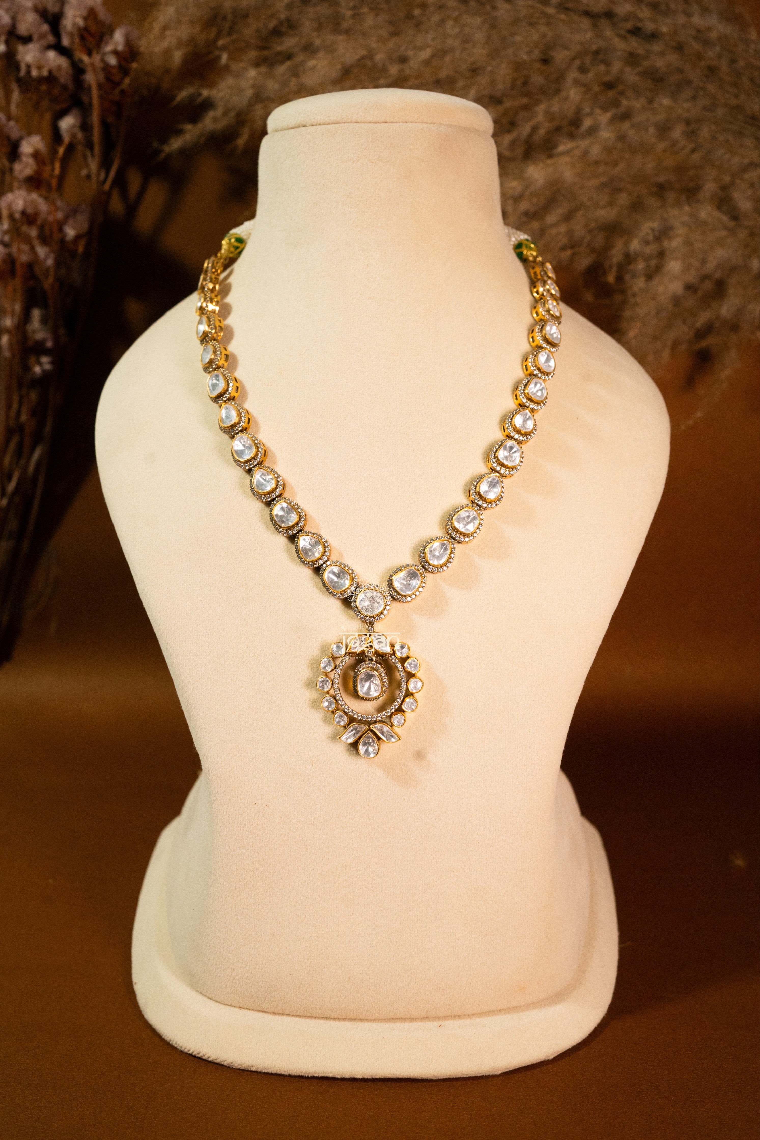 Vasundhara necklace set with lab grown polki stones and gold-plated 92.5 sterling silver, featuring detailed Indian floral motifs and intricate craftsmanship.

