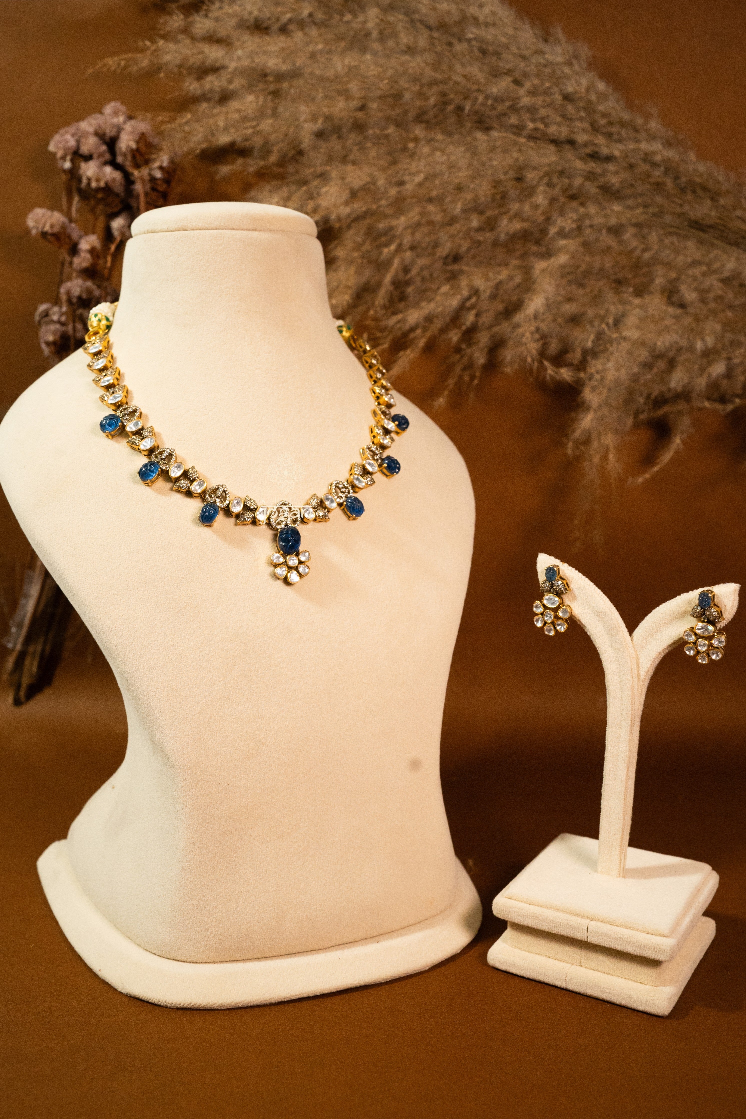 Indraneel necklace set with lab grown polkis, gold-plated 92.5 sterling silver and deep blue carved semi-precious stones, inspired by royal Indian heritage.
