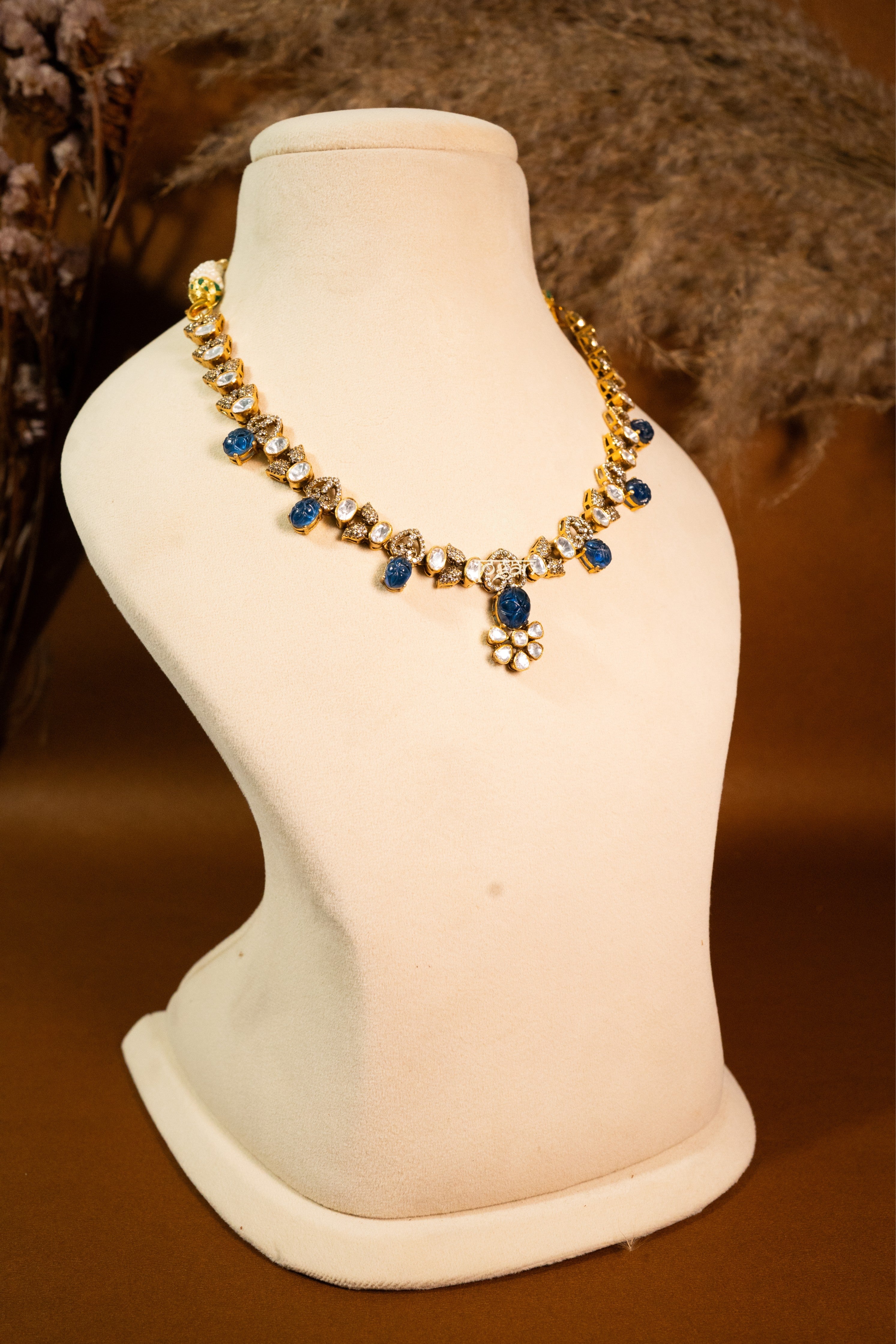 Indraneel necklace set with lab grown polkis, gold-plated 92.5 sterling silver and deep blue carved semi-precious stones, inspired by royal Indian heritage.

