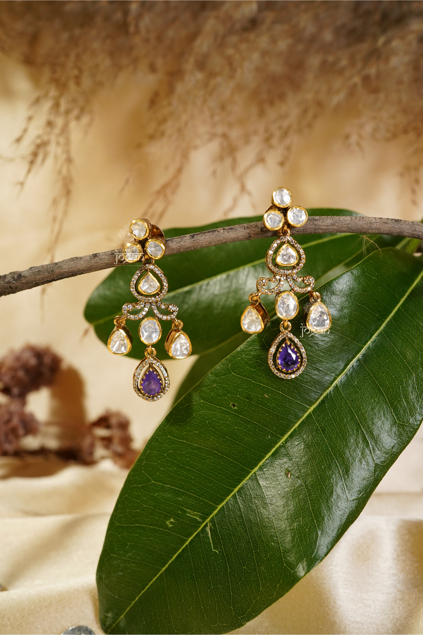 Shobhita tiered dangler earrings featuring luminous lab-grown Polkis and an amethyst-toned semi-precious stone drop in gold-plated metal, offering graceful movement and refined sparkle for cocktail parties, festive occasions, and elegant evenings