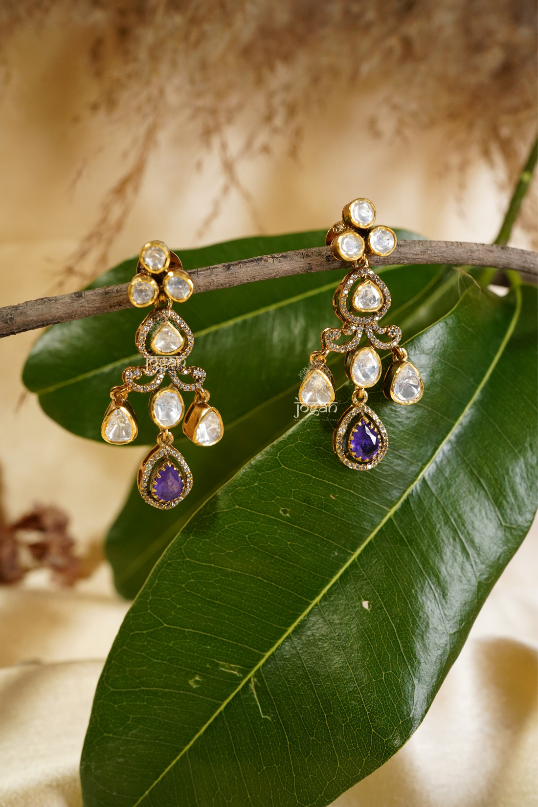 Shobhita tiered dangler earrings featuring luminous lab-grown Polkis and an amethyst-toned semi-precious stone drop in gold-plated metal, offering graceful movement and refined sparkle for cocktail parties, festive occasions, and elegant evenings
