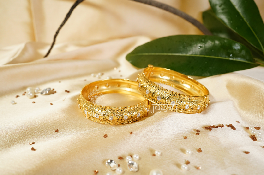 Intricate gold-plated Suvarnaa Kadaa with shimmering lab-grown Polkis, featuring a wide, ornate design. These traditional Indian bangles are perfect for cultural events, weddings, and festive occasions like Diwali or Eid. The elegant filigree work and radiant stones appeal to those seeking authentic, high-quality Indian jewelry with a touch of modern luxury. Suitable for women of all ages and a great gift option.
