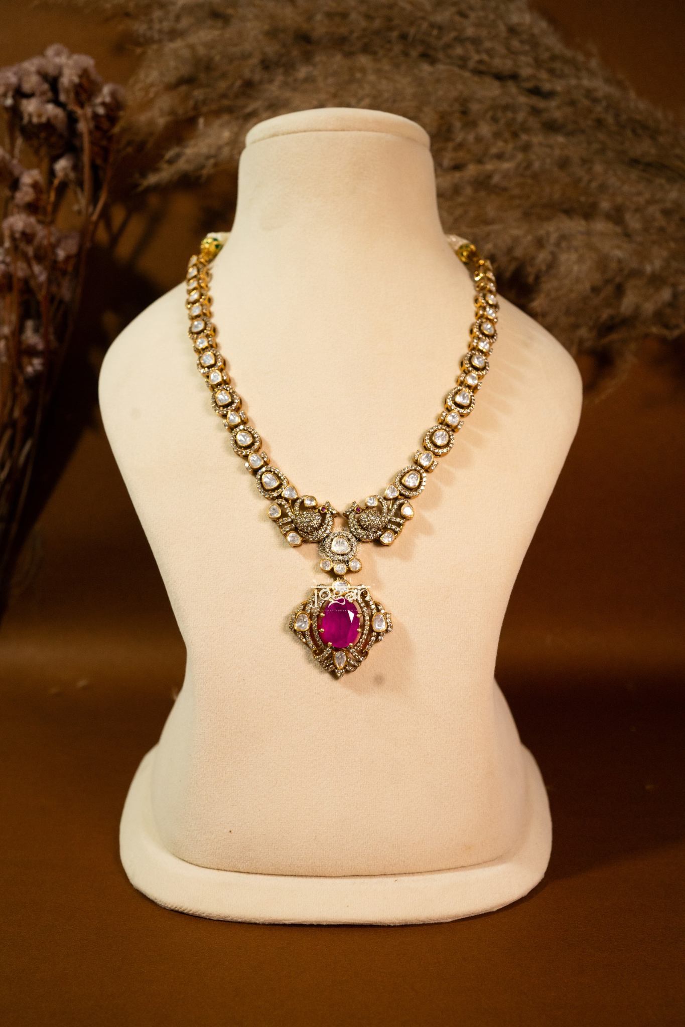 Manikya Durbaar necklace set featuring ruby-toned semi-precious centerpiece, framed with CZs and lab-grown Polkis in gold finish — ideal for weddings, festivities, and Indo-western looks.